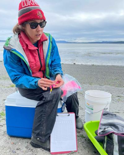 Olivia Graham, eelgrass researcher in the field with her collecting supplies