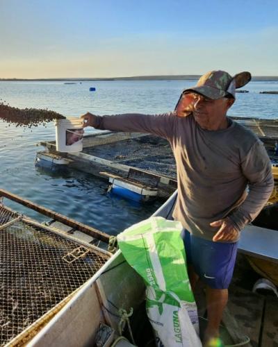 An aquaculturist feeds his fish in Palmas, Tocantins, Brazil. Felipe Pacheco/Provided